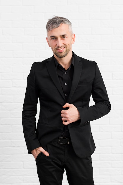 Man in black suit unbutton his jacket