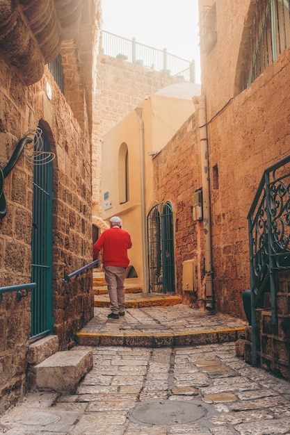 Free Photo man in blue jacket walking on sidewalk during daytime