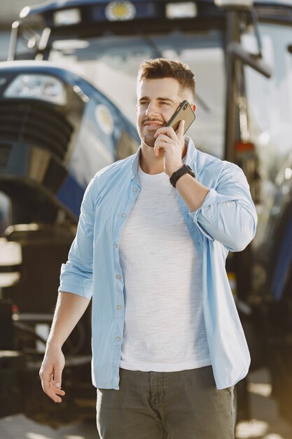 Man in a blue shirt. Guy in a tractor. Agricultural machinery.