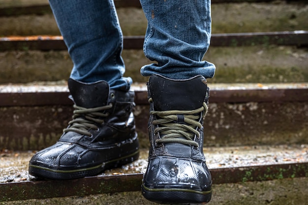 Free photo a man in boots on the old steps closeup