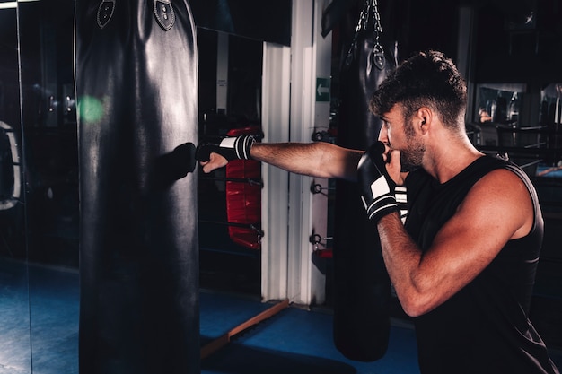 Free Photo man boxing in gym