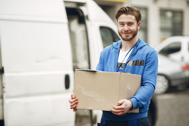 Free photo man by the truck. guy in a delivery uniform.