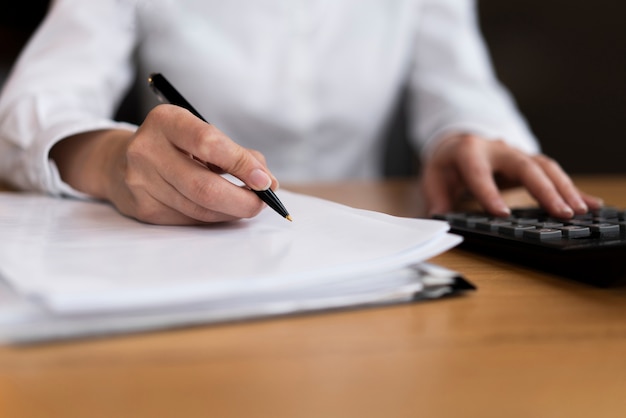 Man calculating and writing close up