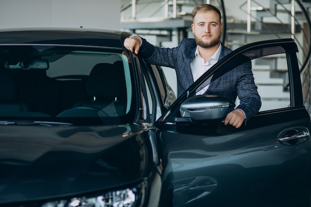 Free Photo man in car showroom choosing a car