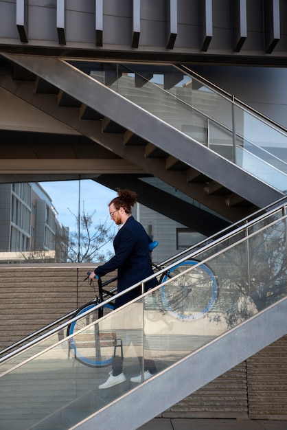 Man carrying bicycle down the stairs full shot