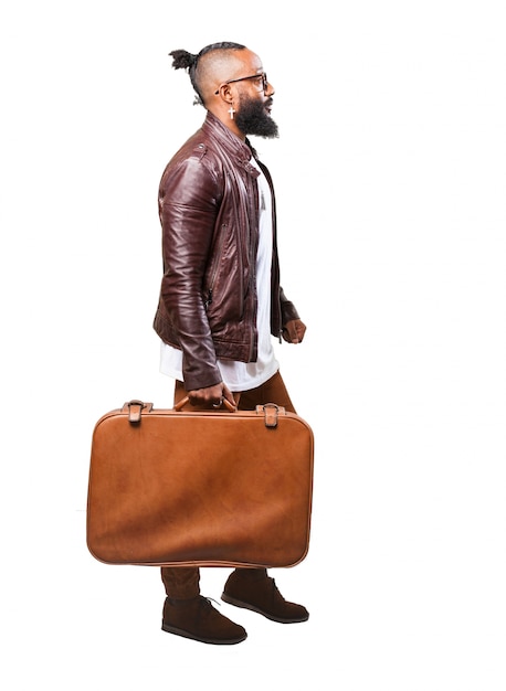 Man carrying a brown suitcase