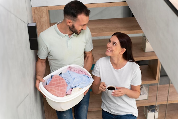 Man carrying a bunch of dirty clothes in the basket