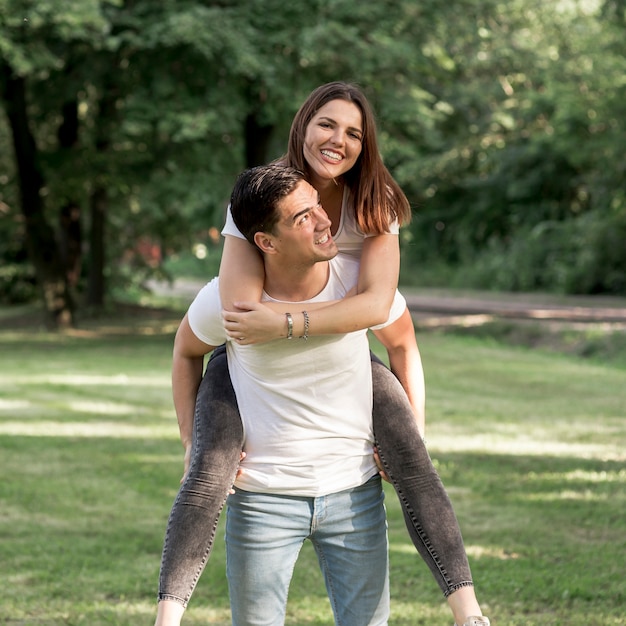 Man carrying his girlfriend on his back