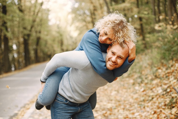 Free Photo man carrying woman piggyback