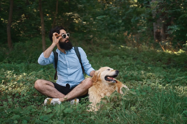 Man in casual clothes and his dog looking surprised to left