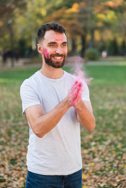 Man celebrating holi with colors