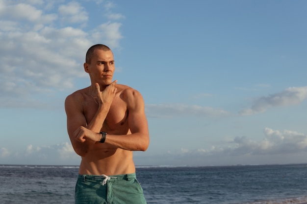 A man checks his pulse after training. bali