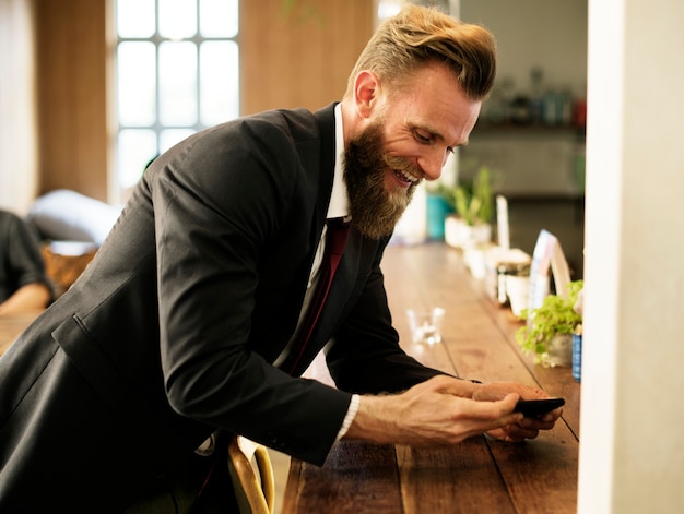 Free Photo man chilling out at coffee shop with mobile phone