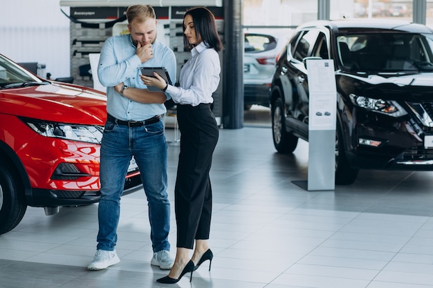 Man choosing a car and talking with salesperson