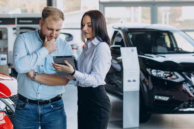 Man choosing a car and talking with salesperson