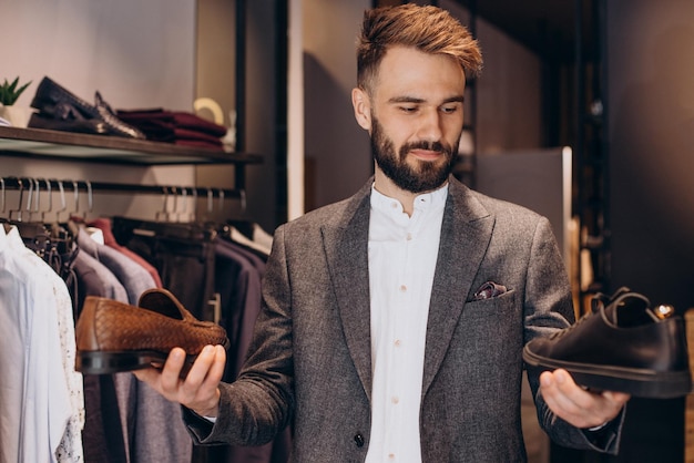 Free Photo man choosing foot wear at mens store