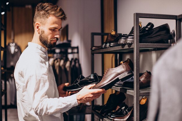 Man choosing foot wear at mens store