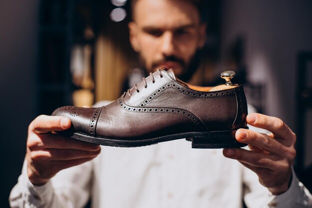 Man choosing foot wear at mens store