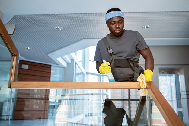 Man cleaning railing medium shot