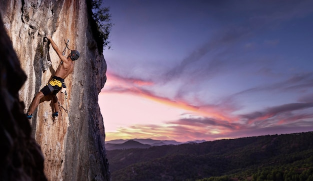 Free Photo man climbing on a mountain with safety equipment