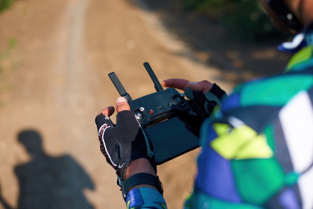 Man controlling a drone in the forest