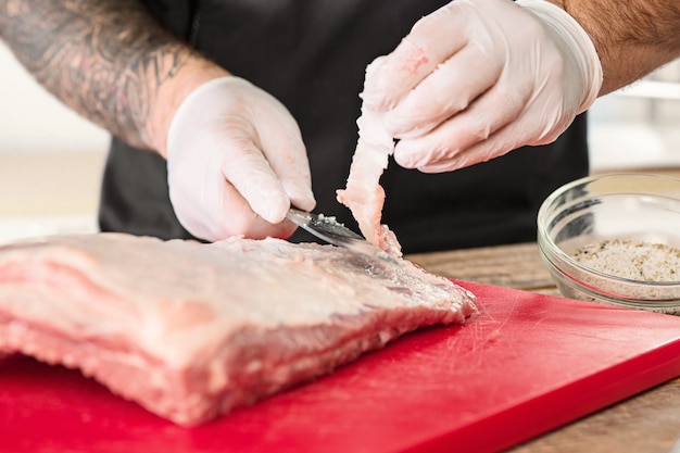 Free Photo man cooking meat steak on kitchen