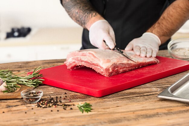 Man cooking meat steak on kitchen