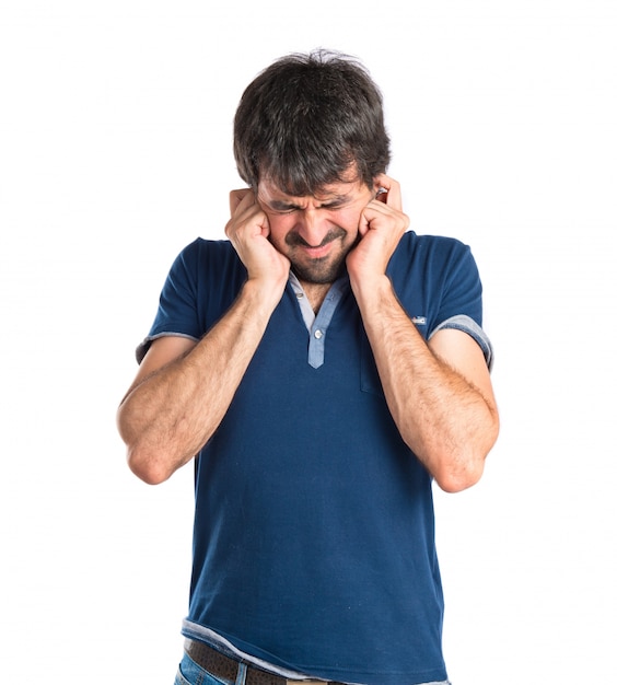 Man covering his ears over white background