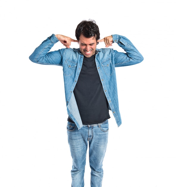 Free Photo man covering his ears over white background