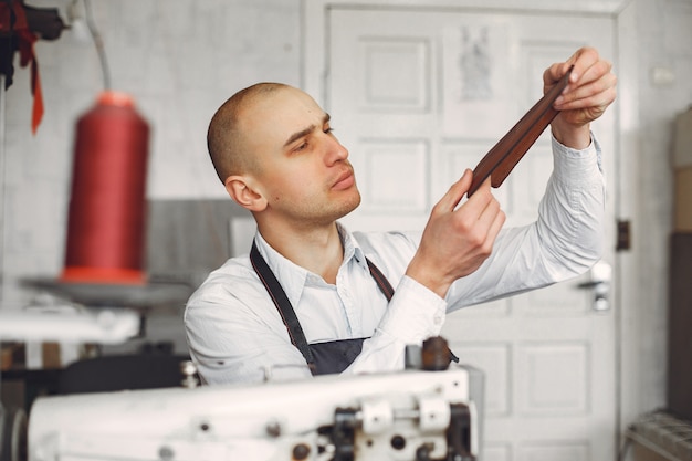 Free photo man  creates leather ware