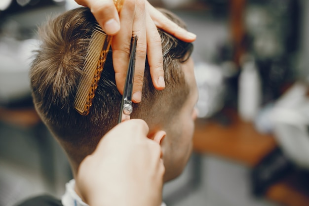 A man cuts hair in a barbershop