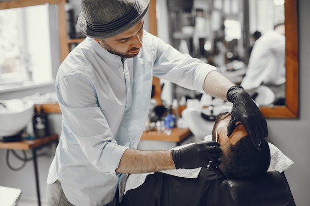 Free Photo the man cuts his beard in the barbershop