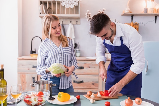 Man cutting vegetable on wooden board 