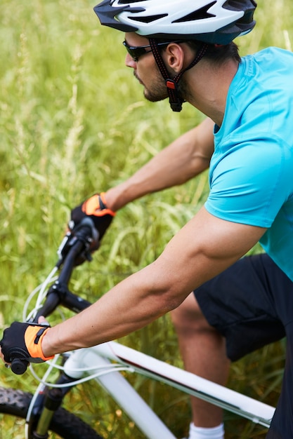 Free Photo man cycling across the meadow