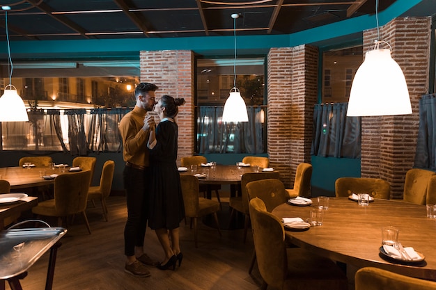 Man dancing with woman in restaurant