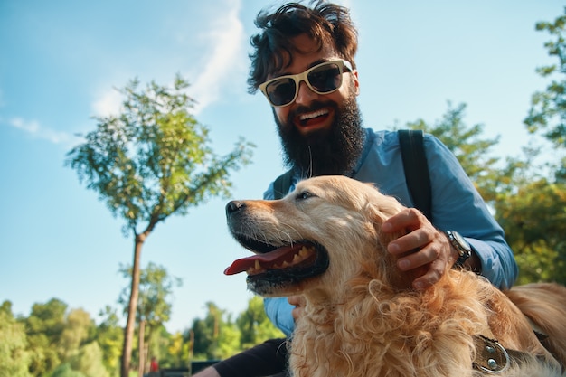 Man and dog having fun, playing, making funny faces