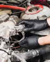 Free photo man doing repairs on car engine