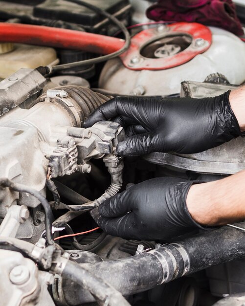 Man doing repairs on car engine