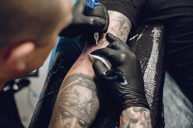 Man doing a tattoo in a tattoo salon