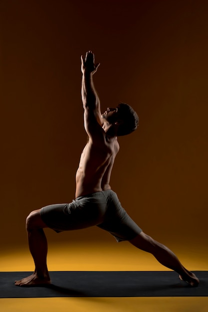 Man doing yoga in high lounge pose