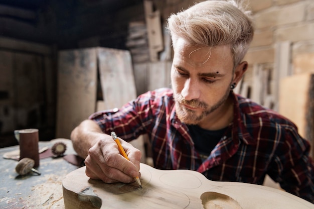 Free Photo man drawing on wood