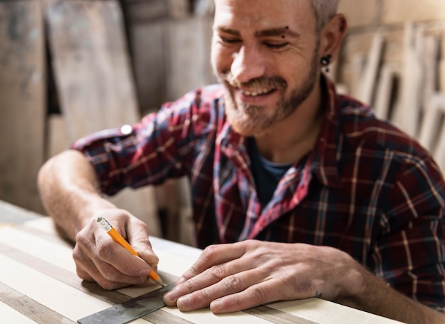 Free photo man drawing on wood