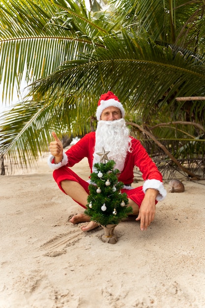 Free Photo man dressed in santa claus celebrating christmas in july