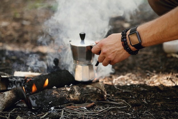 Free photo man drinking coffee in forest