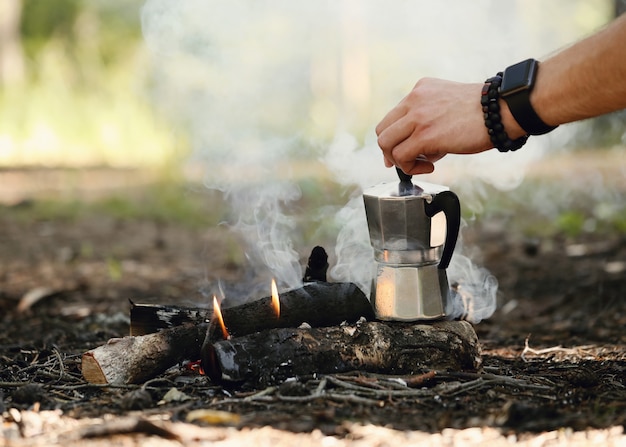 man drinking coffee in forest