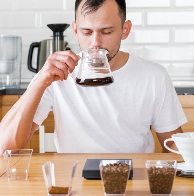 Free Photo man drinking coffee indoors