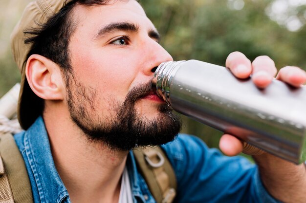 Man drinking from thermos