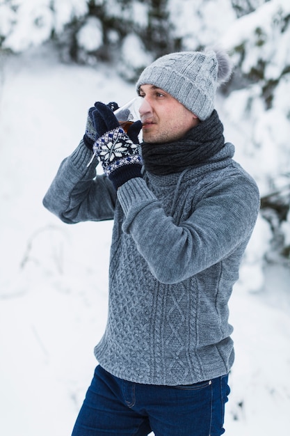 Free photo man drinking tea in winter