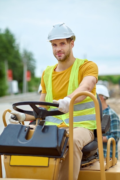 Free Photo man driving special vehicle looking at camera