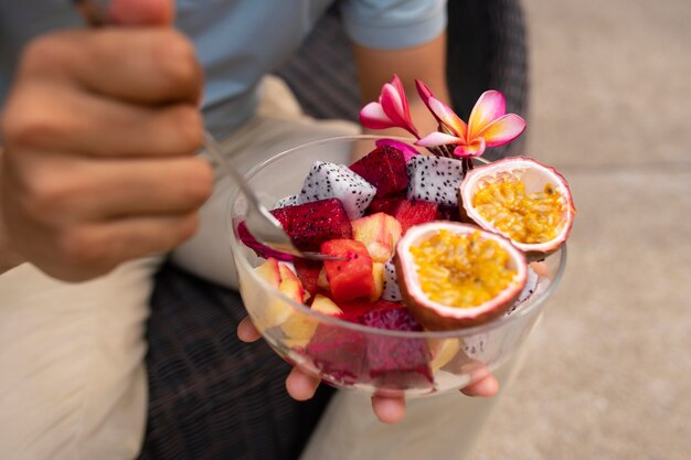 Man eating dragon fruit outdoors